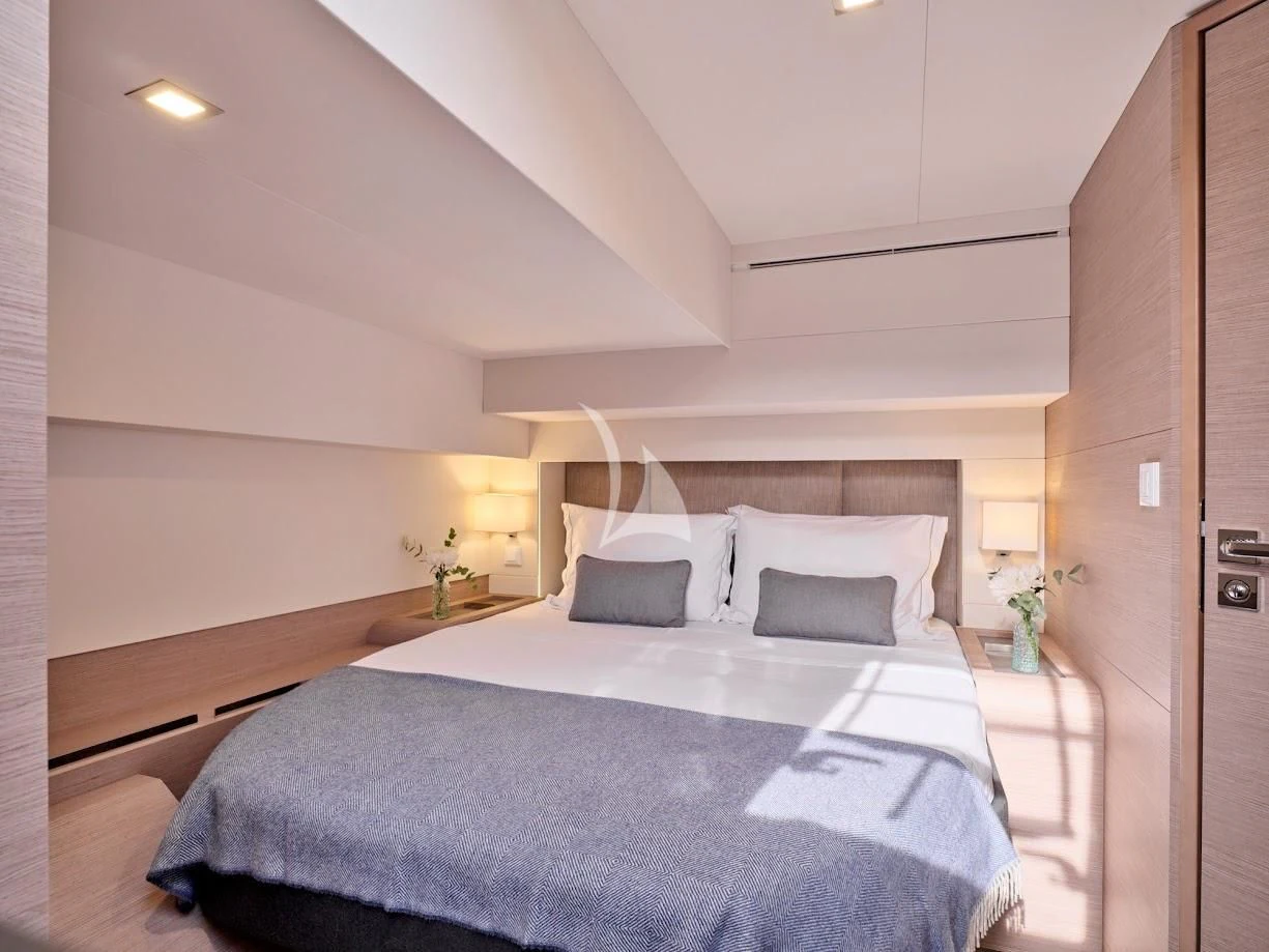 a bed with a white pillow aboard DOLLY Yacht for Charter