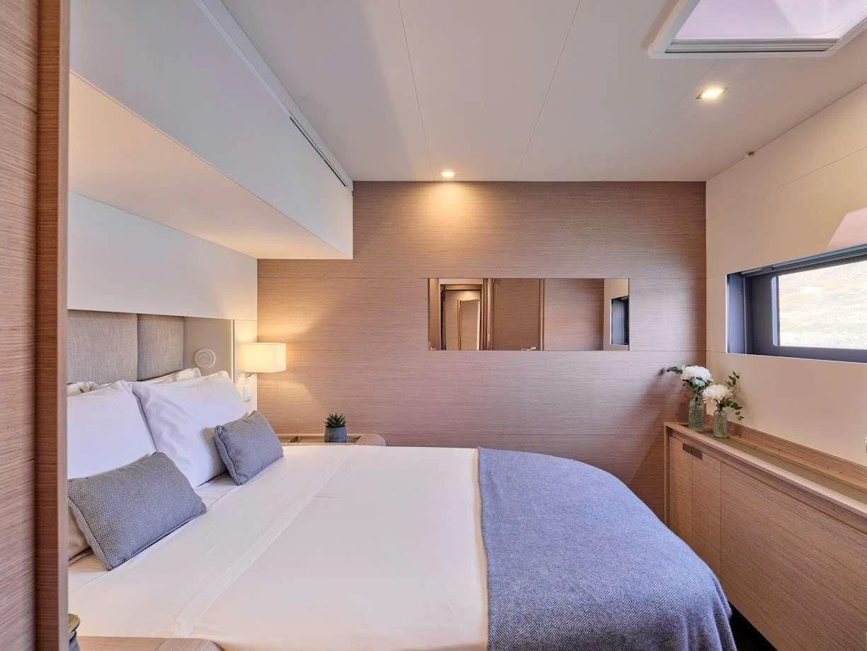 a bedroom with a bed and a mirror aboard DOLLY Yacht for Charter