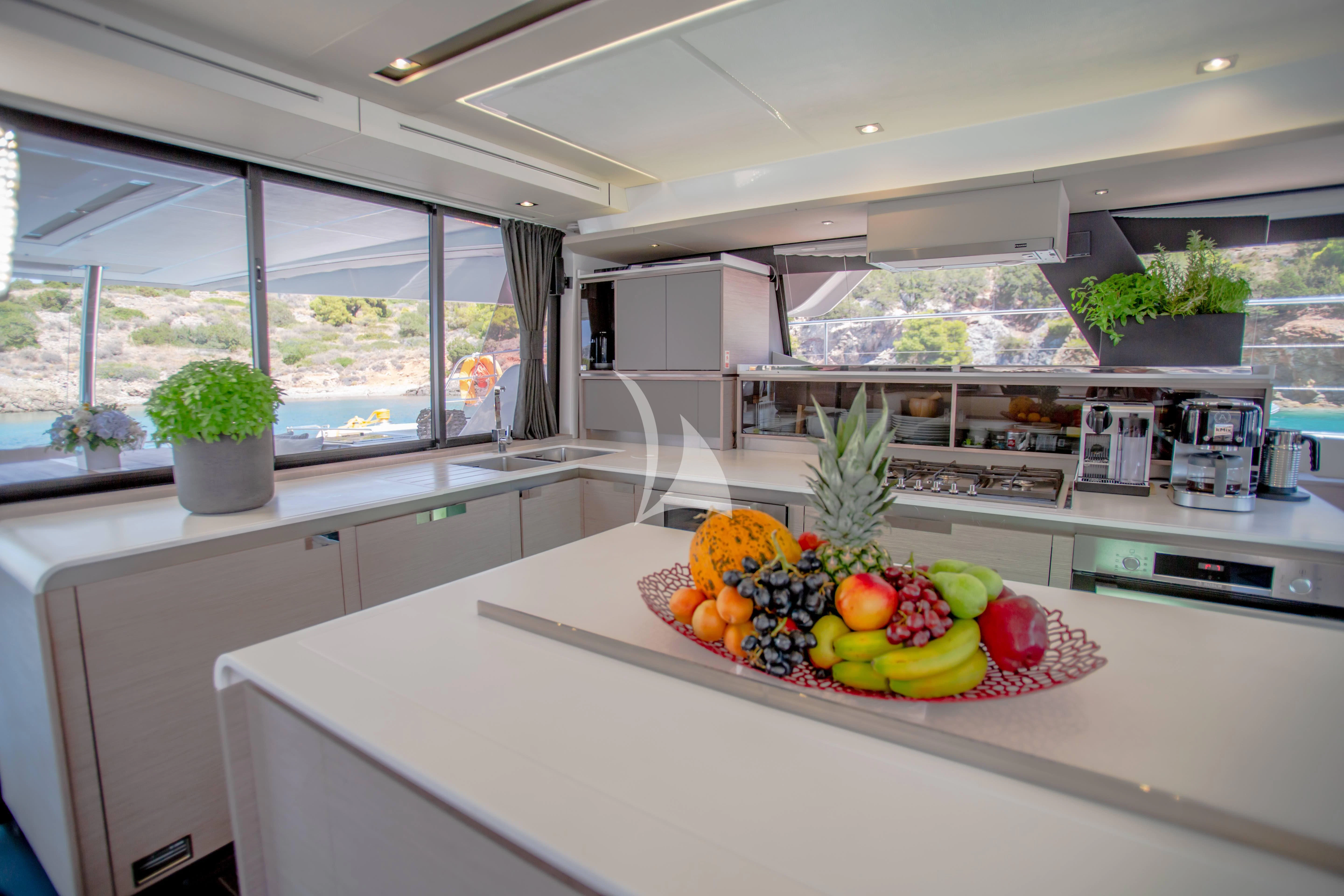 a kitchen with a large window aboard DOLLY Yacht for Charter