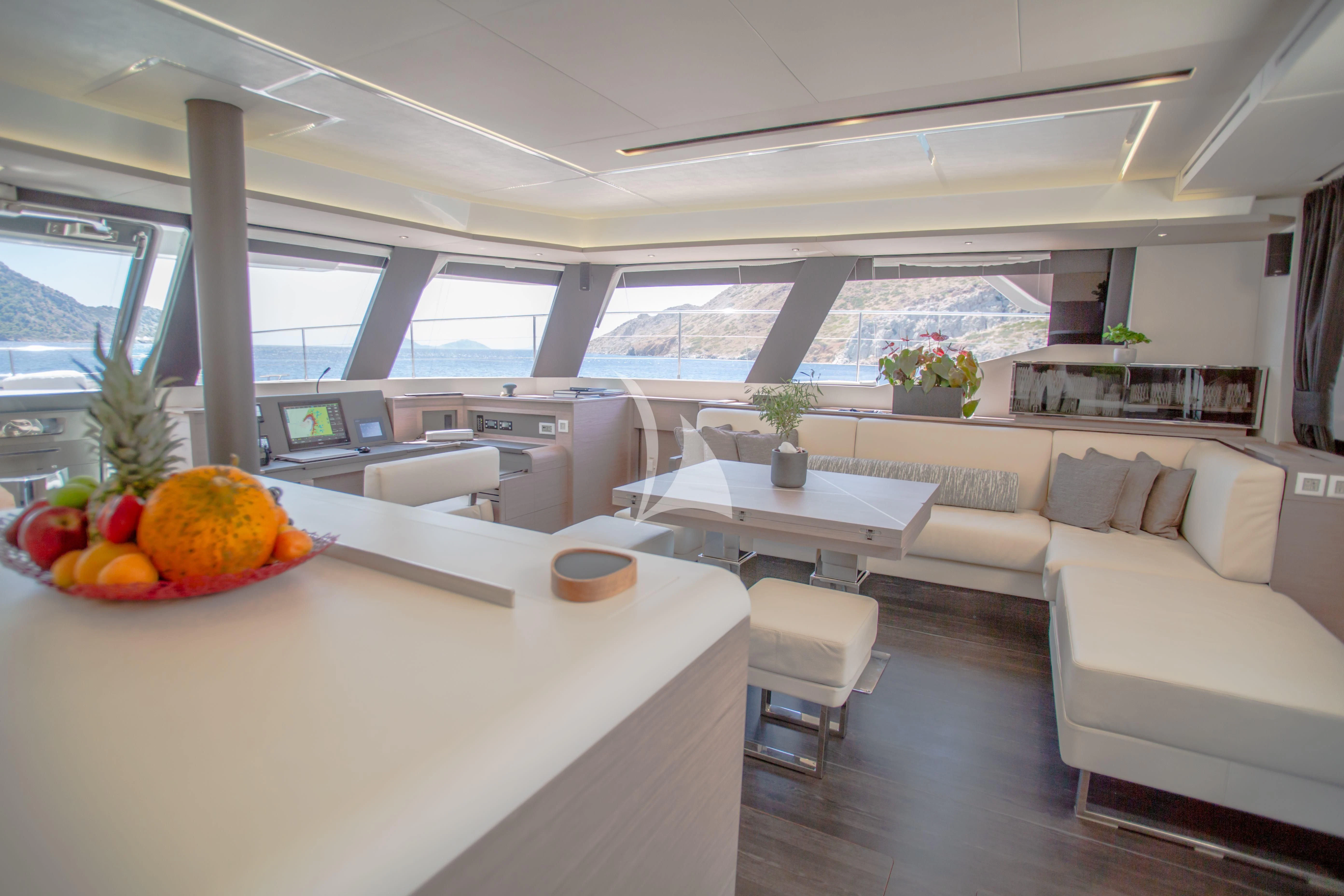 a room with a table and couches aboard DOLLY Yacht for Charter