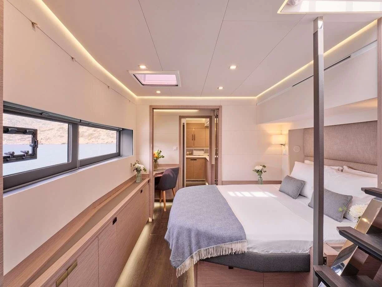 a bedroom with a bed and a desk aboard DOLLY Yacht for Charter