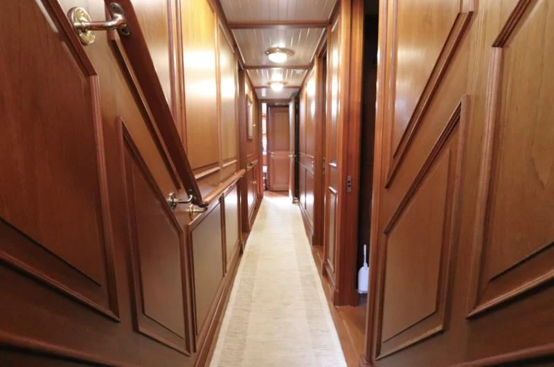 a hallway with wooden cabinets aboard KEEWAYDIN Yacht for Sale
