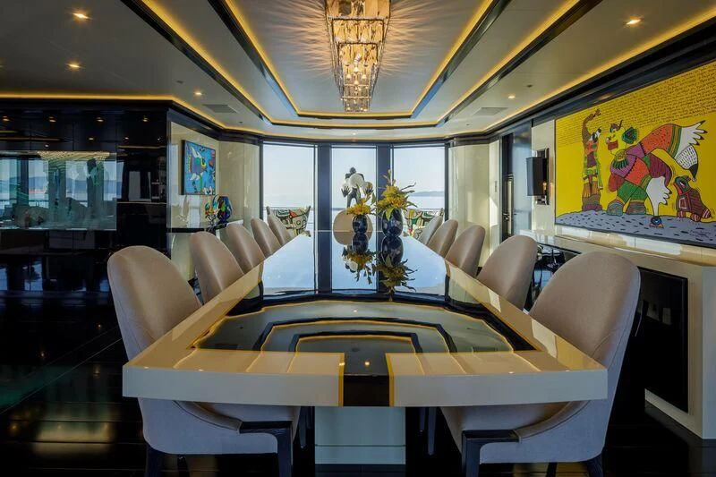 a room with tables and chairs aboard LADY VERA Yacht for Sale