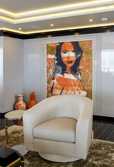 a white couch with a painting on it aboard LADY VERA Yacht for Sale