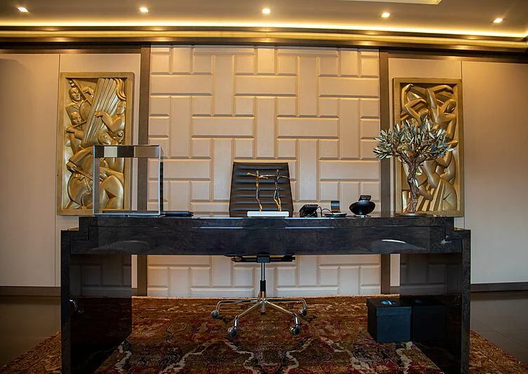 a room with a piano and a stand with a statue on it aboard LADY VERA Yacht for Sale