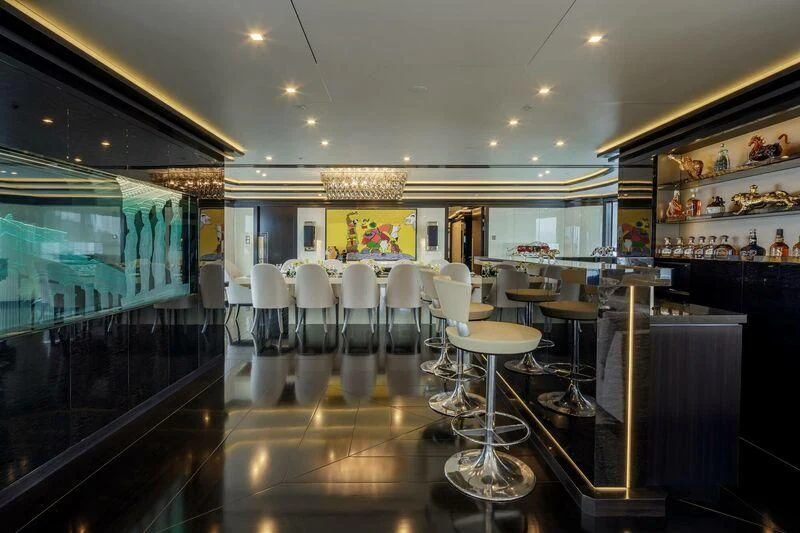 a room with a table chairs and a glass wall aboard LADY VERA Yacht for Sale