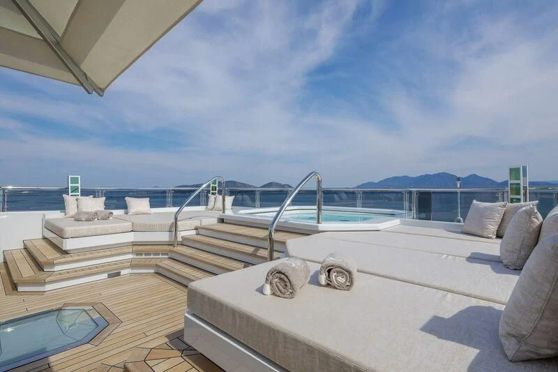 a deck with a pool and a view of the ocean aboard LADY VERA Yacht for Sale