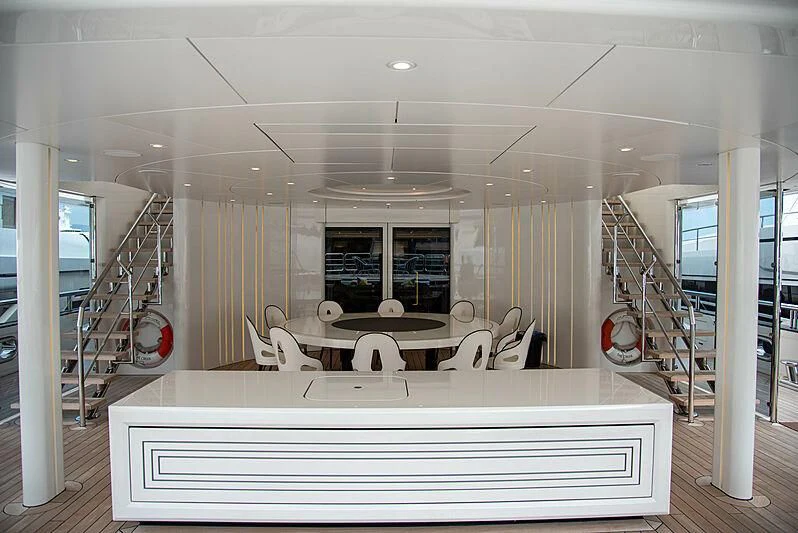 a room with a table chairs and a staircase aboard LADY VERA Yacht for Sale