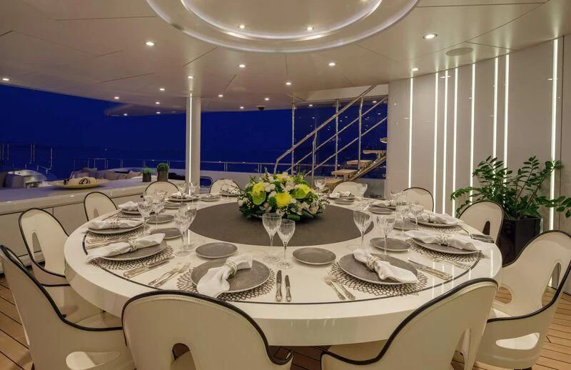 a table set with plates and glasses aboard LADY VERA Yacht for Sale