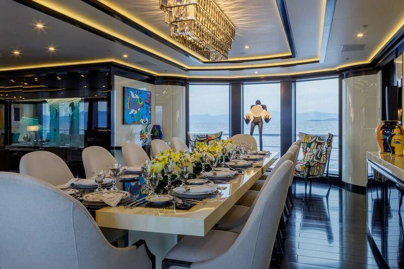 a dining room with a large window aboard LADY VERA Yacht for Sale