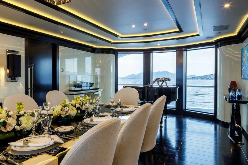 a dining room with a large window aboard LADY VERA Yacht for Sale