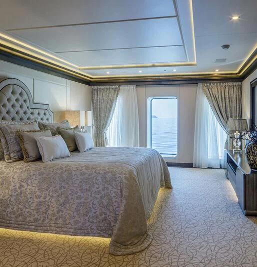 a bedroom with a large bed aboard LADY VERA Yacht for Sale