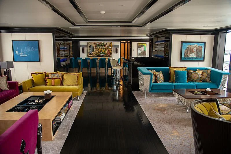 a living room with a large table and chairs aboard LADY VERA Yacht for Sale