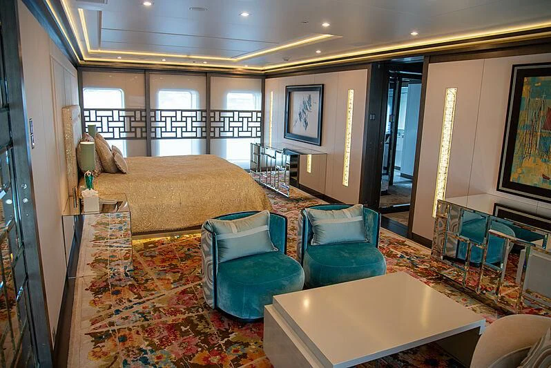 a large living room with a large bed and a table aboard LADY VERA Yacht for Sale