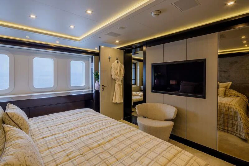 a bedroom with a bed and a television aboard LADY VERA Yacht for Sale
