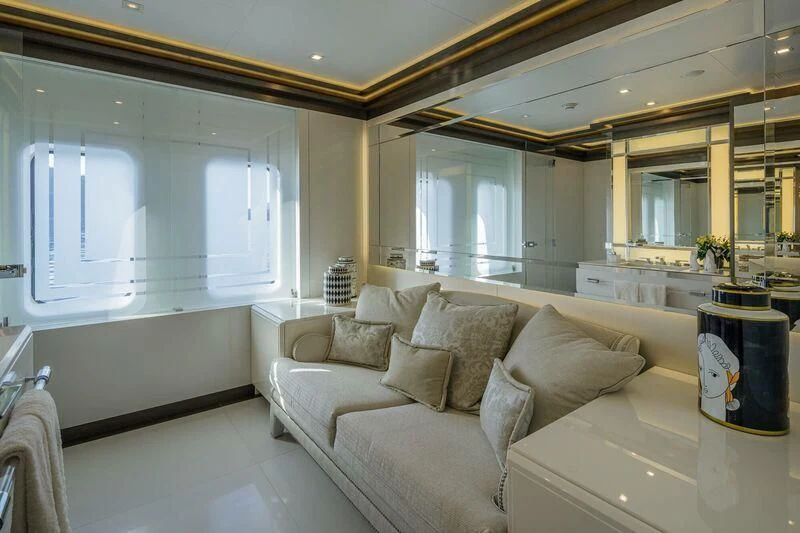 a living room with a couch and a large mirror aboard LADY VERA Yacht for Sale