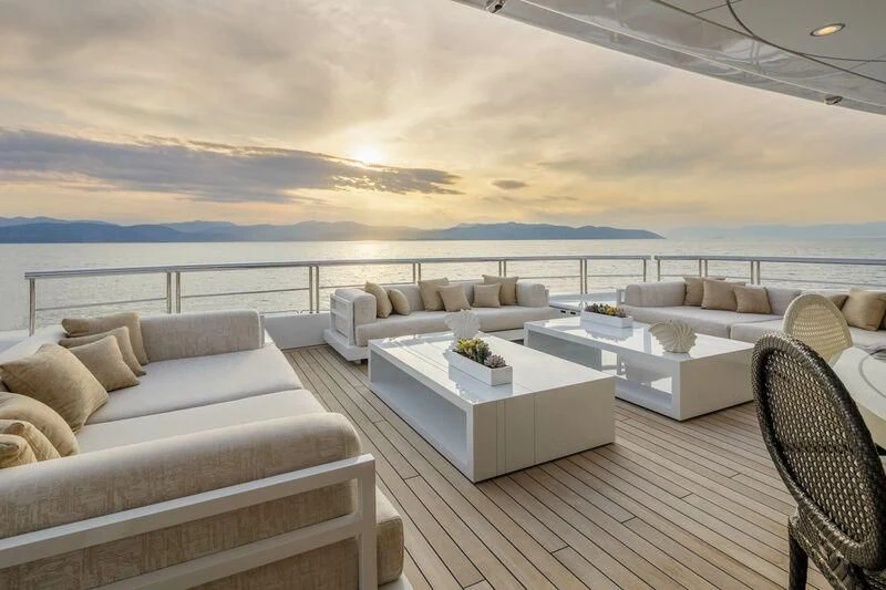 a living room with a large white sofa and a large body of water aboard LADY VERA Yacht for Sale