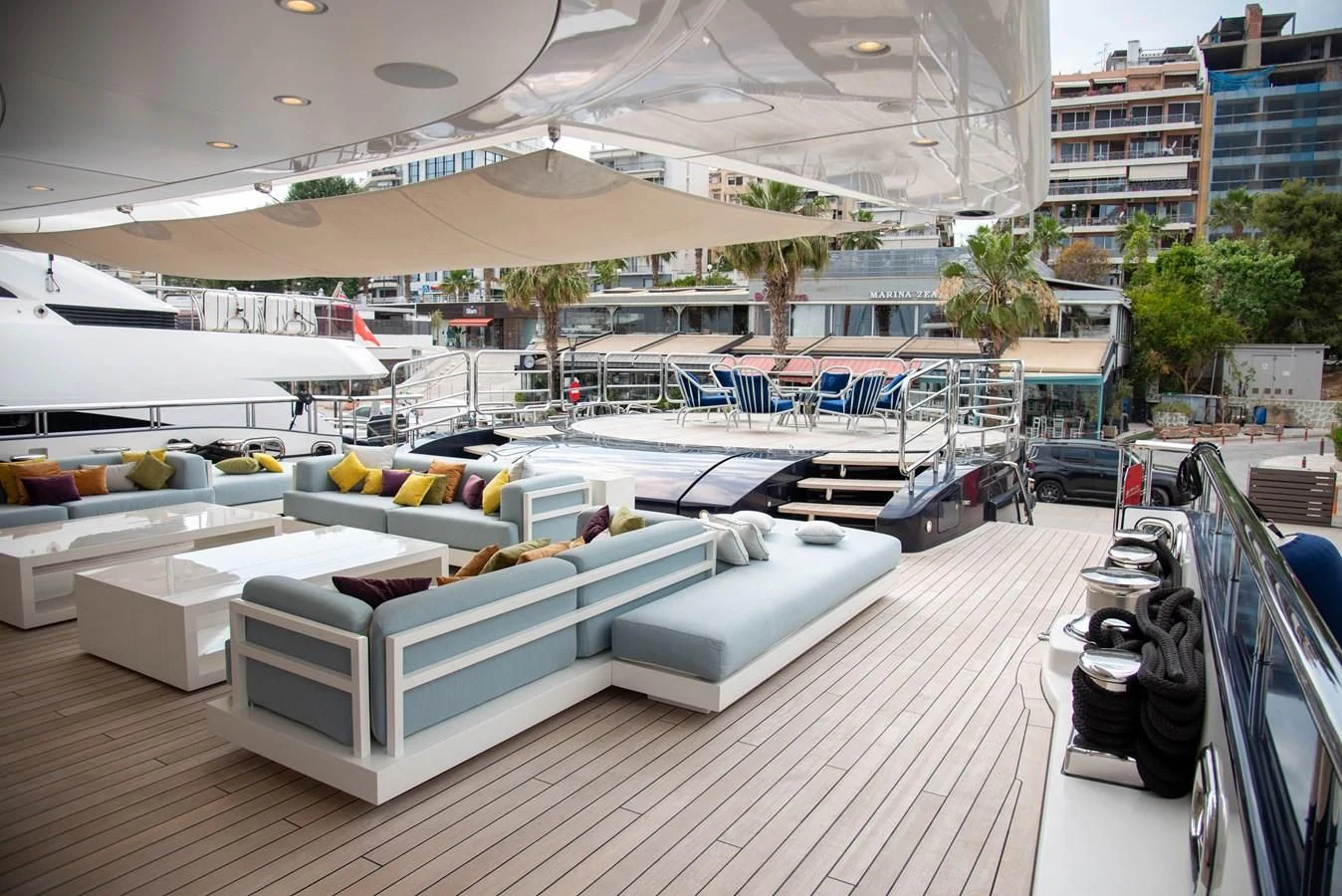 a large white lounge chair in a large room with a pool and a lounge area with a lounge aboard LADY VERA Yacht for Sale