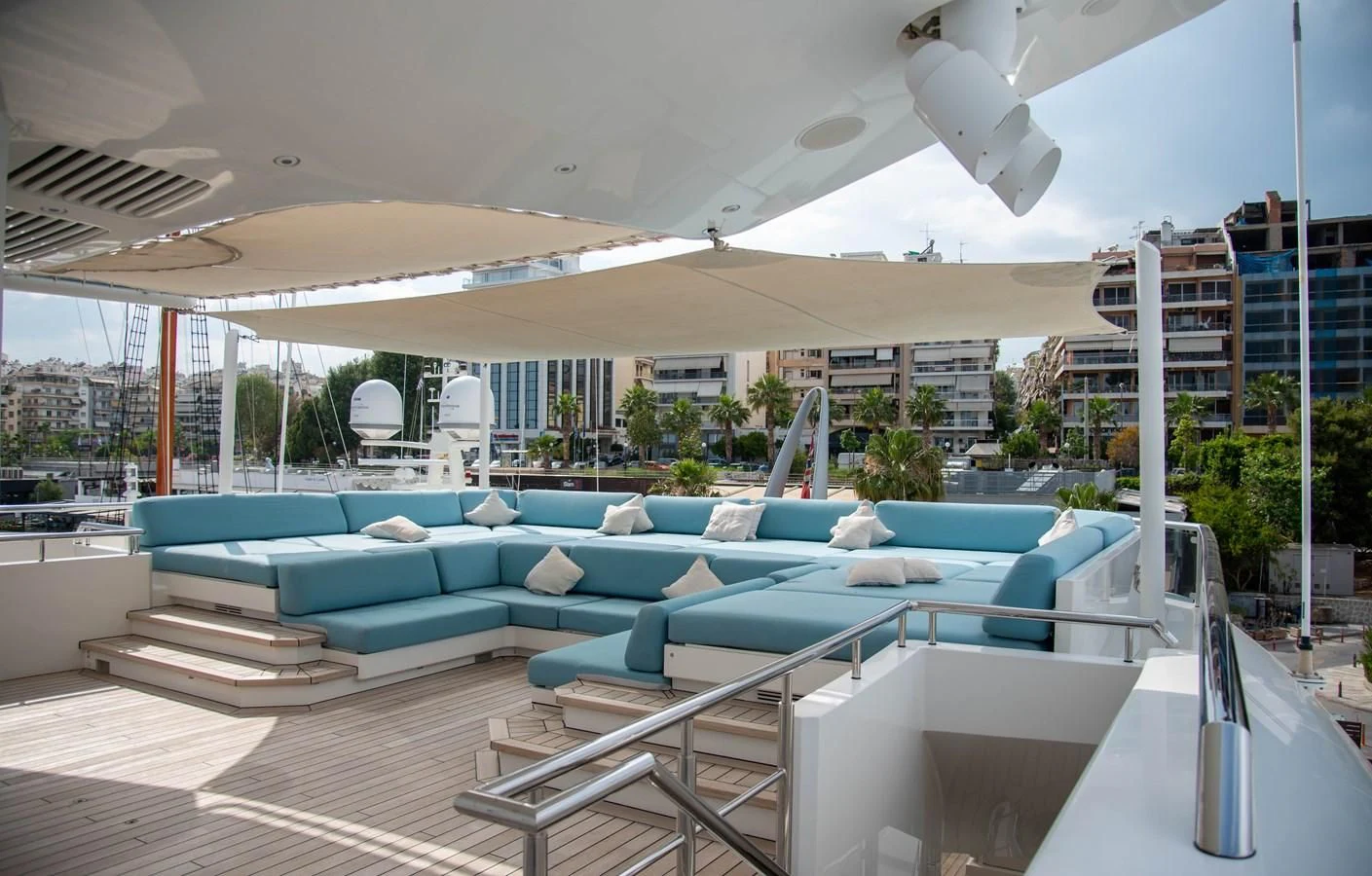 a pool with a deck and a building in the background aboard LADY VERA Yacht for Sale