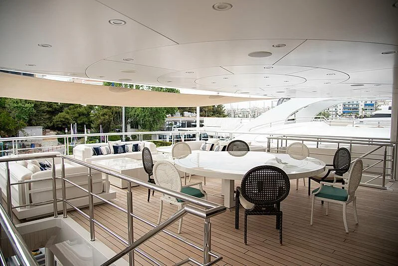 a large room with tables and chairs aboard LADY VERA Yacht for Sale