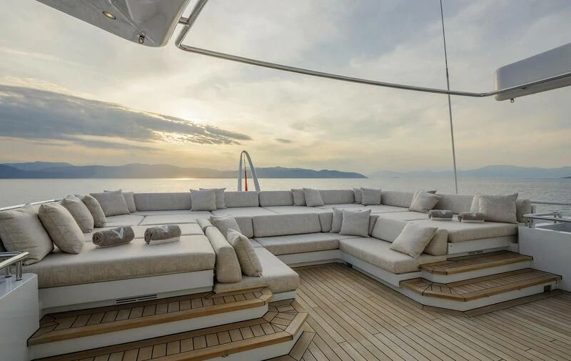 a large lounge area with a large sofa and a large body of water aboard LADY VERA Yacht for Sale