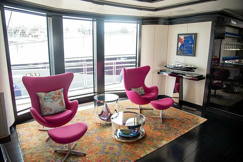 a room with a pink chair and a pink chair aboard LADY VERA Yacht for Sale