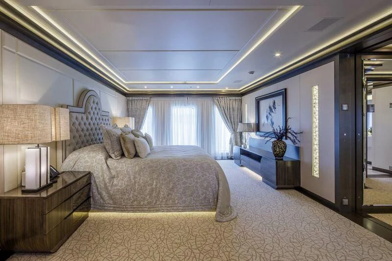 a bedroom with a bed and a desk aboard LADY VERA Yacht for Sale
