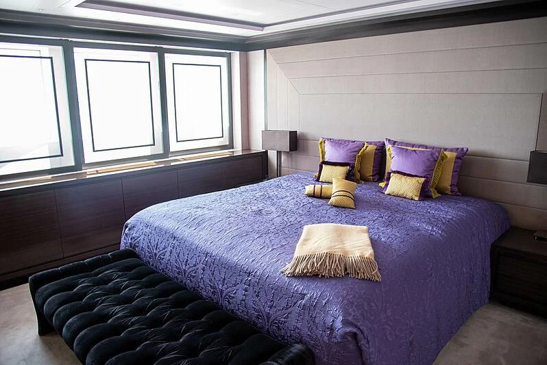 a bedroom with a bed and a window aboard LADY VERA Yacht for Sale