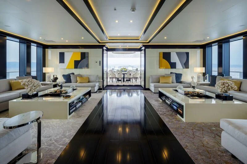 a living room with a large wood floor aboard LADY VERA Yacht for Sale