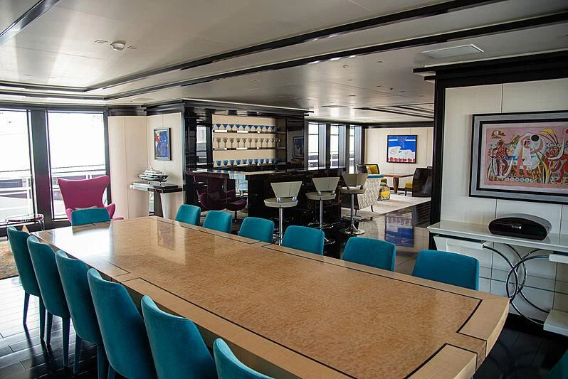 a large room with tables and chairs aboard LADY VERA Yacht for Sale