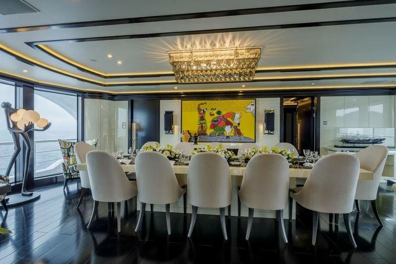 a room with a chandelier and chairs aboard LADY VERA Yacht for Sale