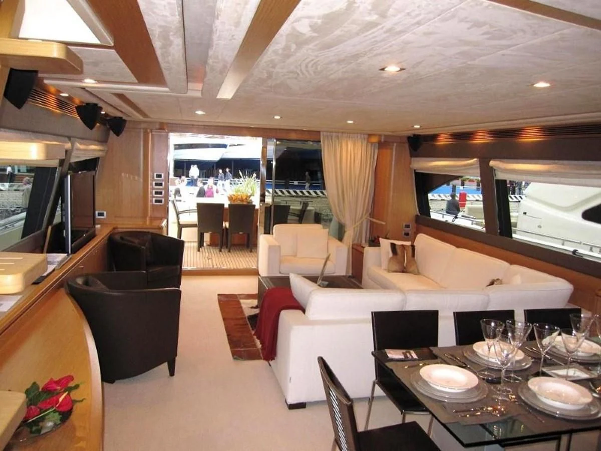 a room with a table chairs and a couch aboard 83' FERRETTI 830 Yacht for Sale