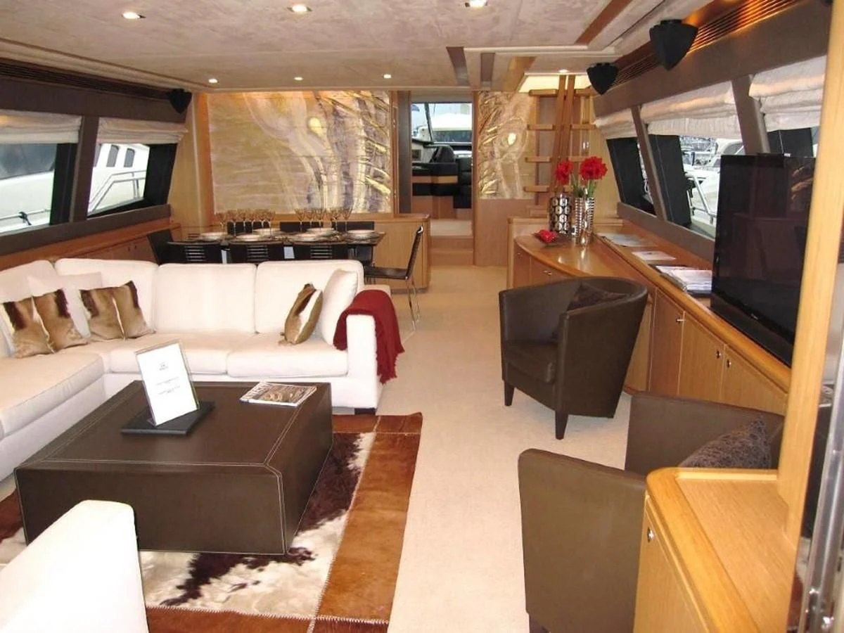 a living room with a large sofa and a coffee table aboard 83' FERRETTI 830 Yacht for Sale