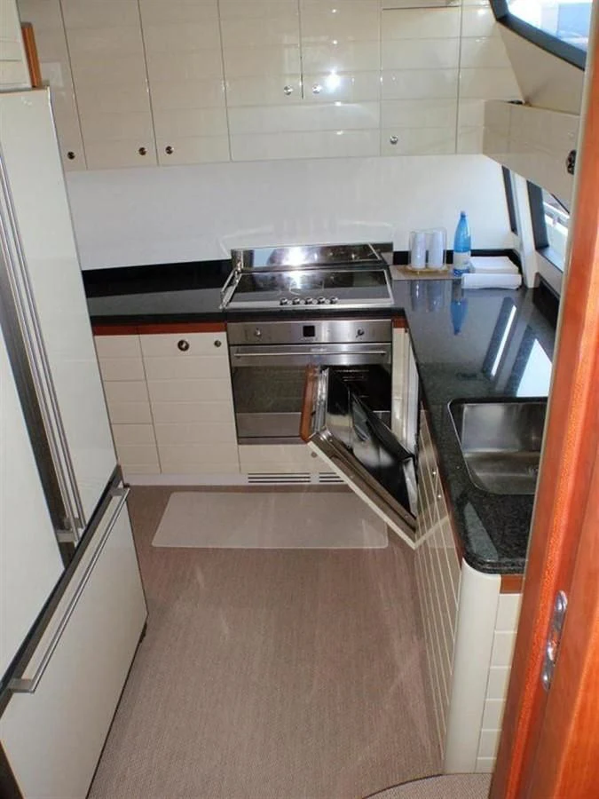 a kitchen with a stove and sink aboard 83' FERRETTI 830 Yacht for Sale