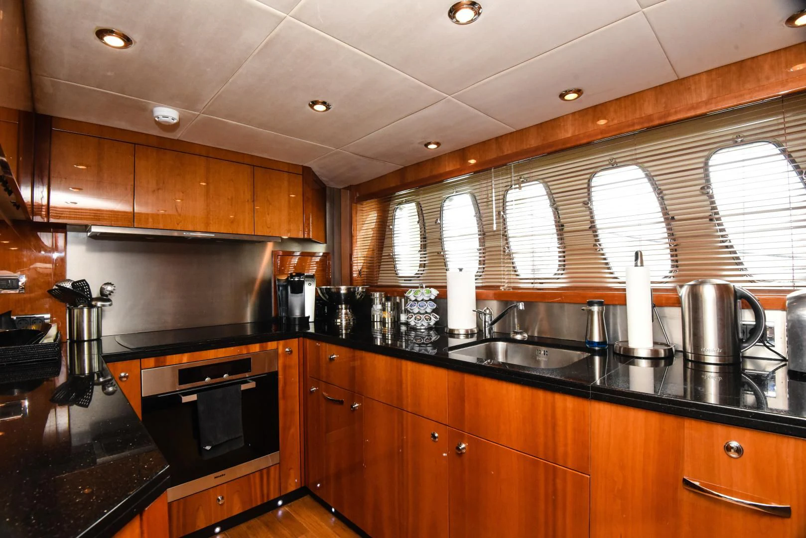 a kitchen with wooden cabinets aboard DIABLO BLANCO Yacht for Sale