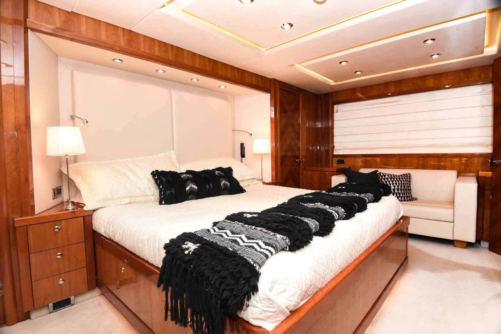 a bedroom with a bed and a couch aboard DIABLO BLANCO Yacht for Sale