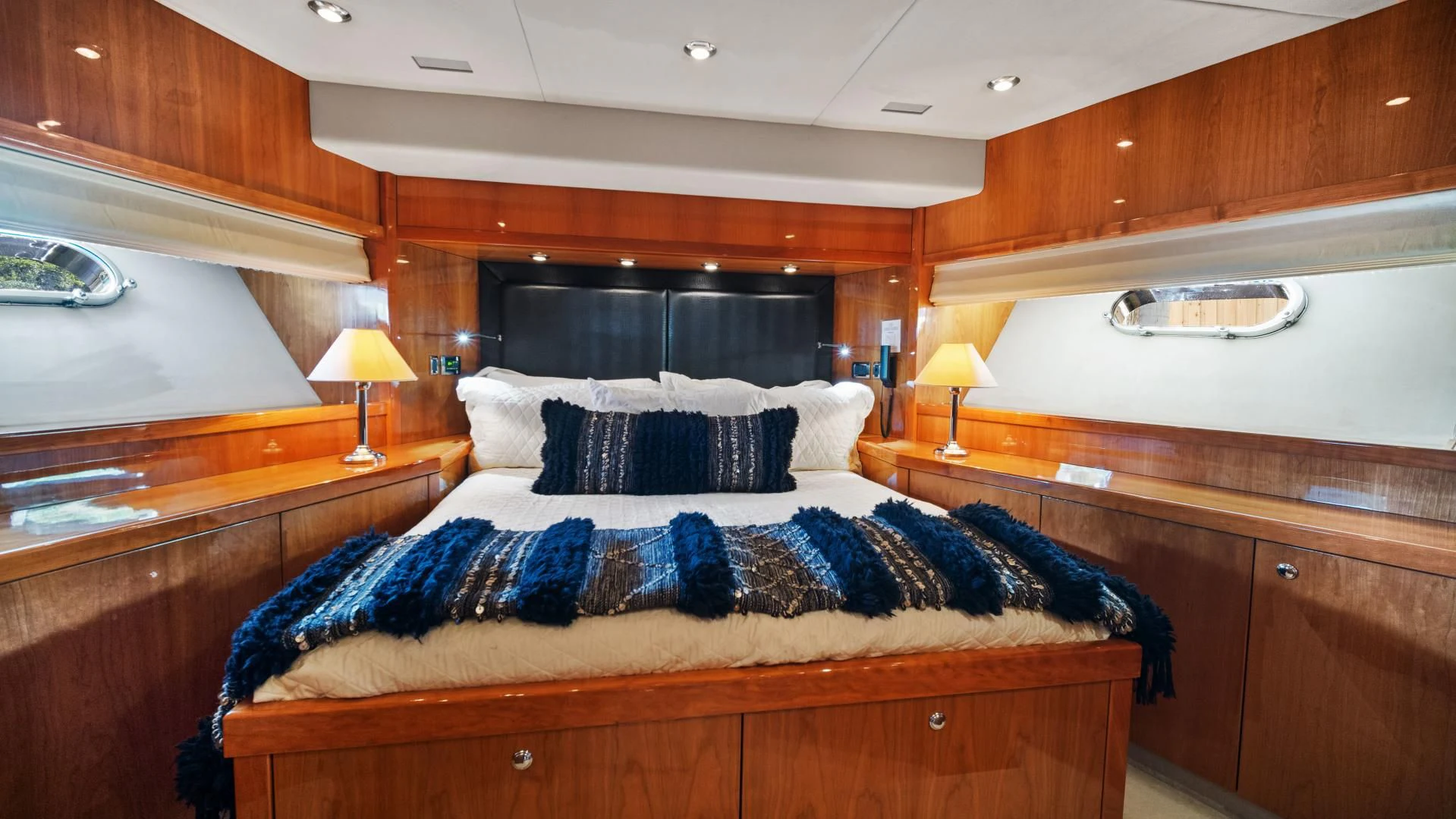 a bedroom with a bed and a desk aboard DIABLO BLANCO Yacht for Sale
