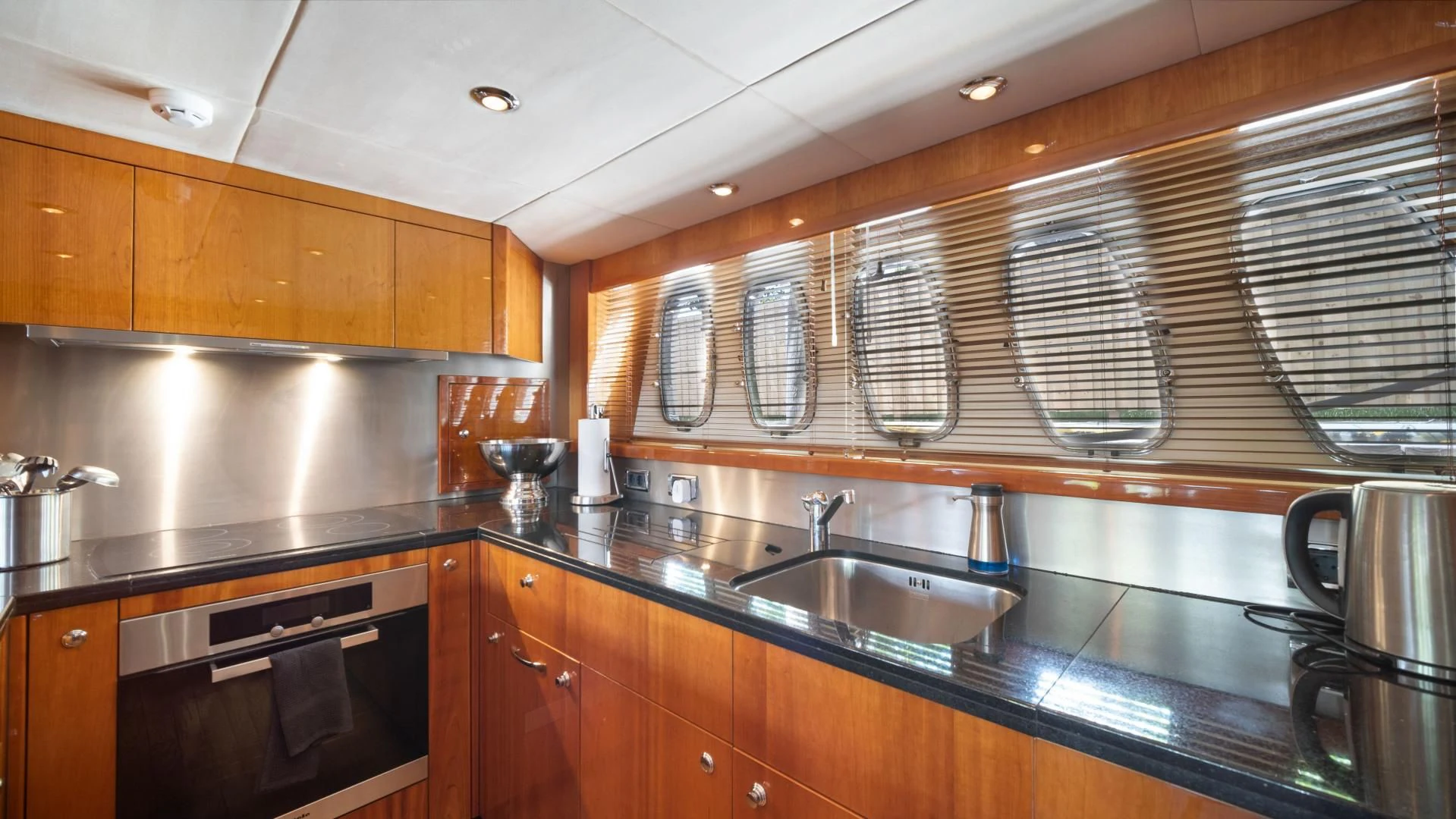 a kitchen with wooden cabinets aboard DIABLO BLANCO Yacht for Sale