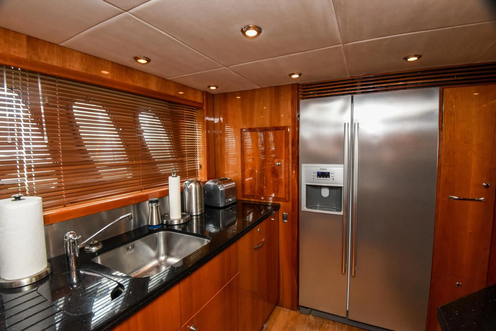 a kitchen with a stainless steel refrigerator aboard DIABLO BLANCO Yacht for Sale