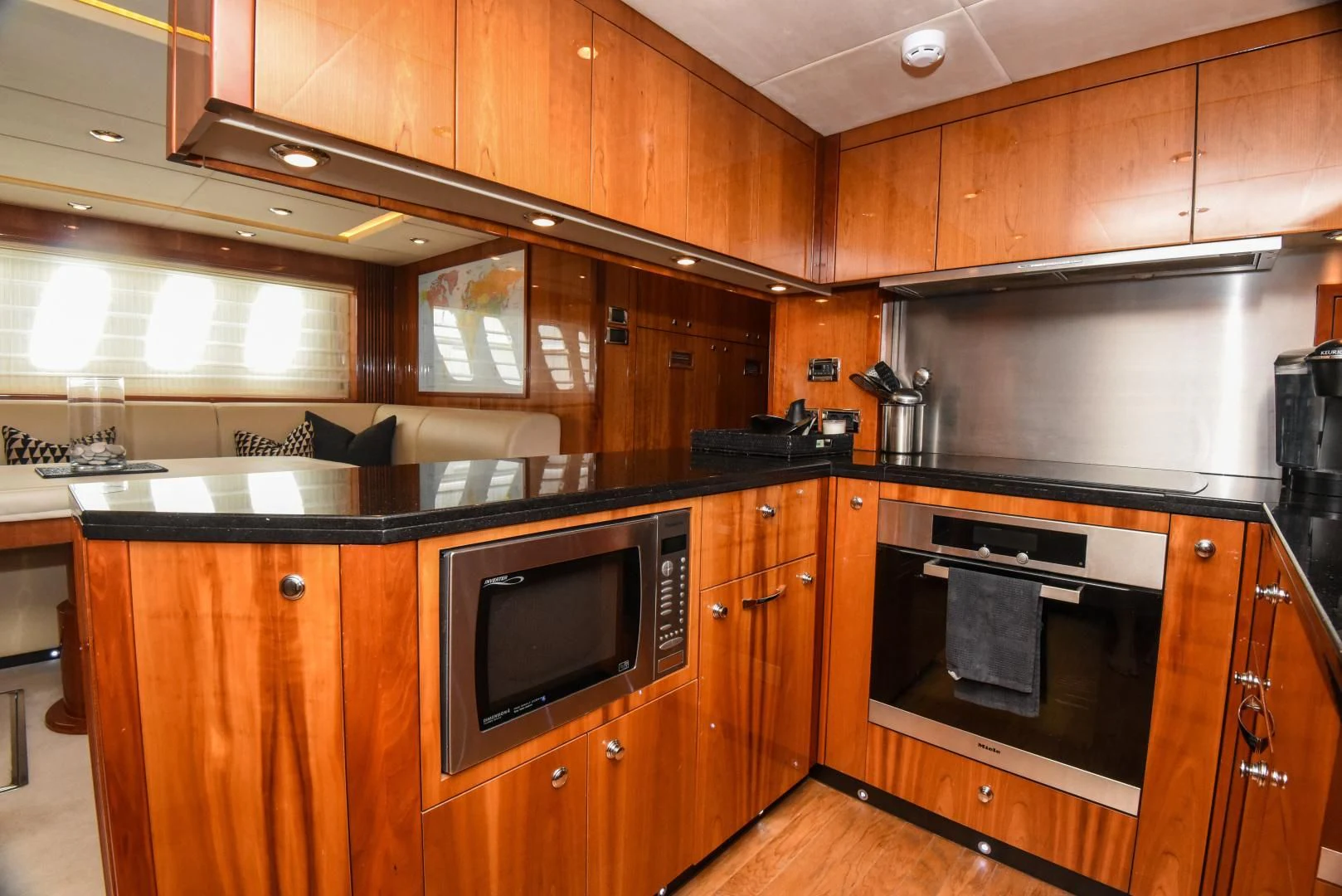 a kitchen with wooden cabinets aboard DIABLO BLANCO Yacht for Sale