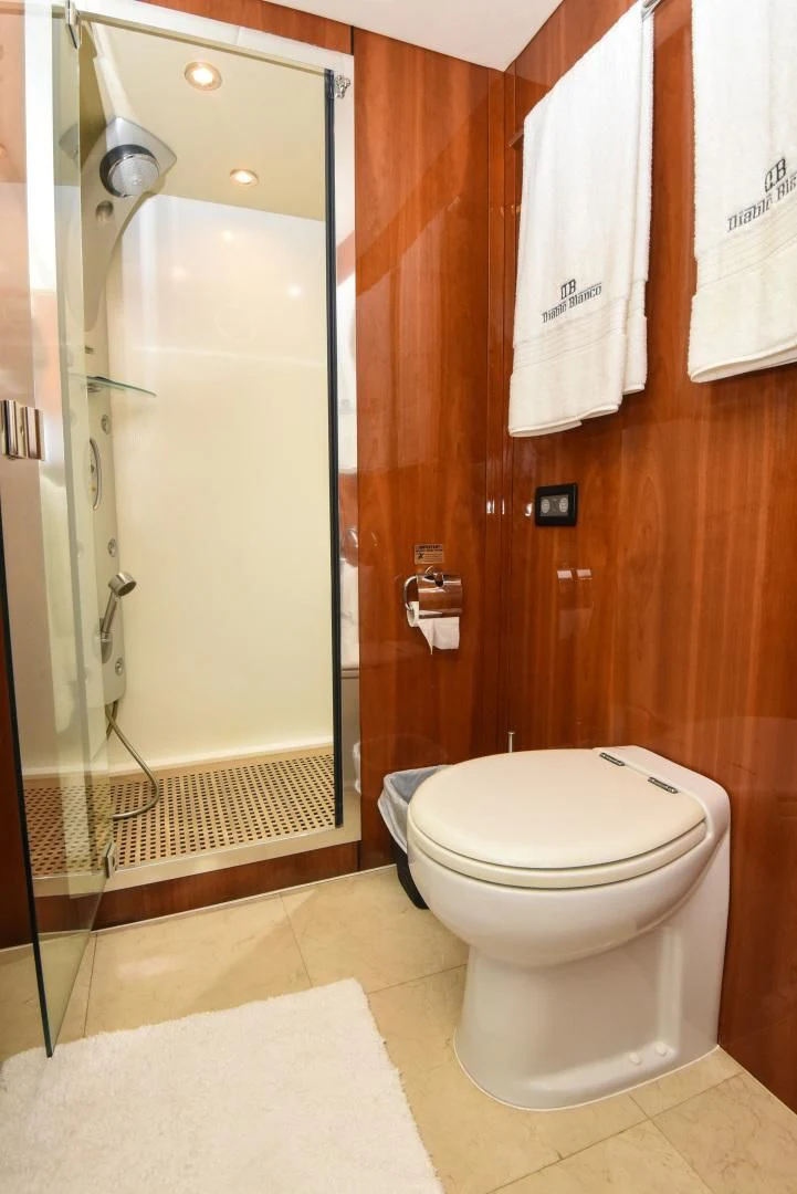 a bathroom with a glass shower door aboard DIABLO BLANCO Yacht for Sale