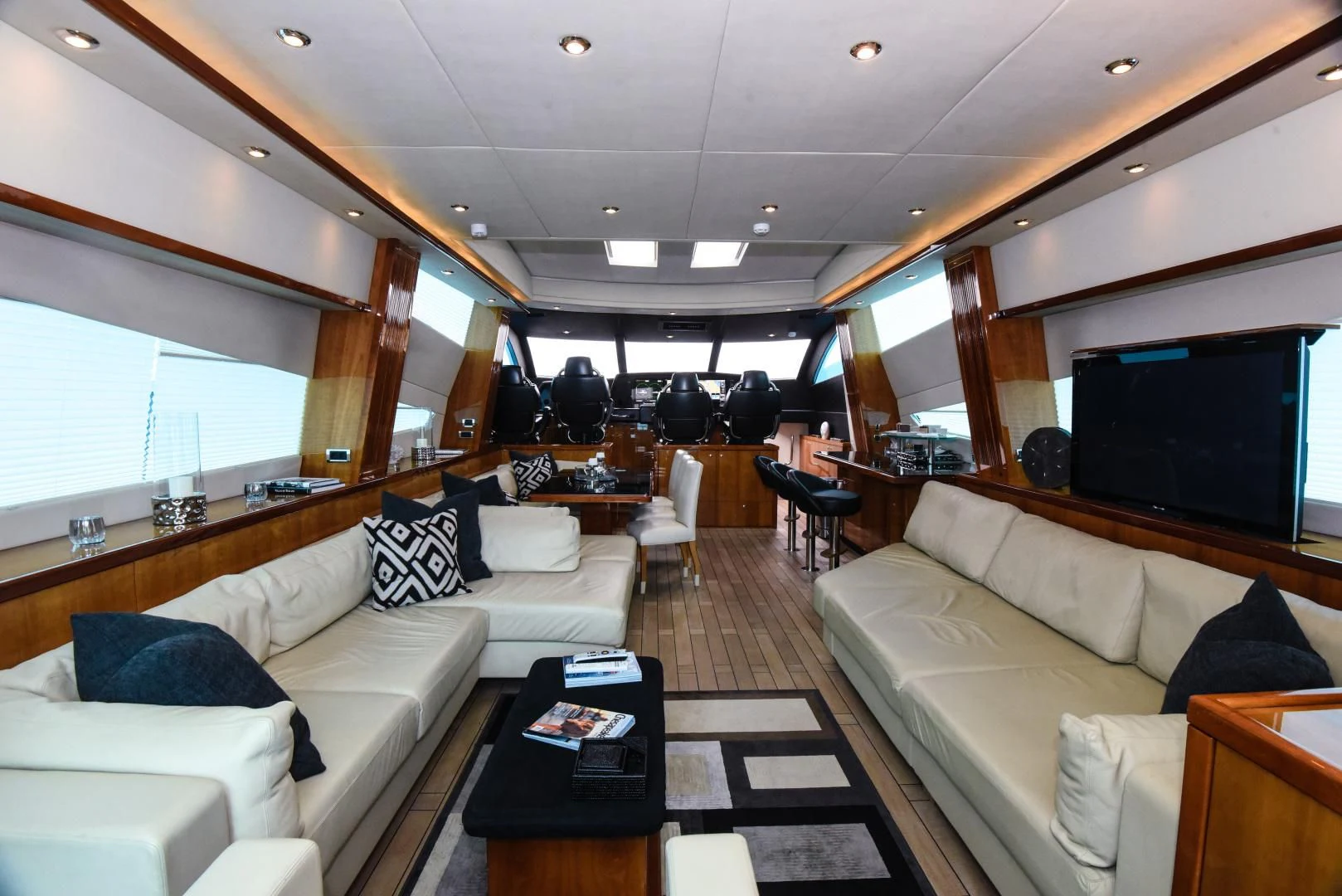a living room with a black and white rug aboard DIABLO BLANCO Yacht for Sale