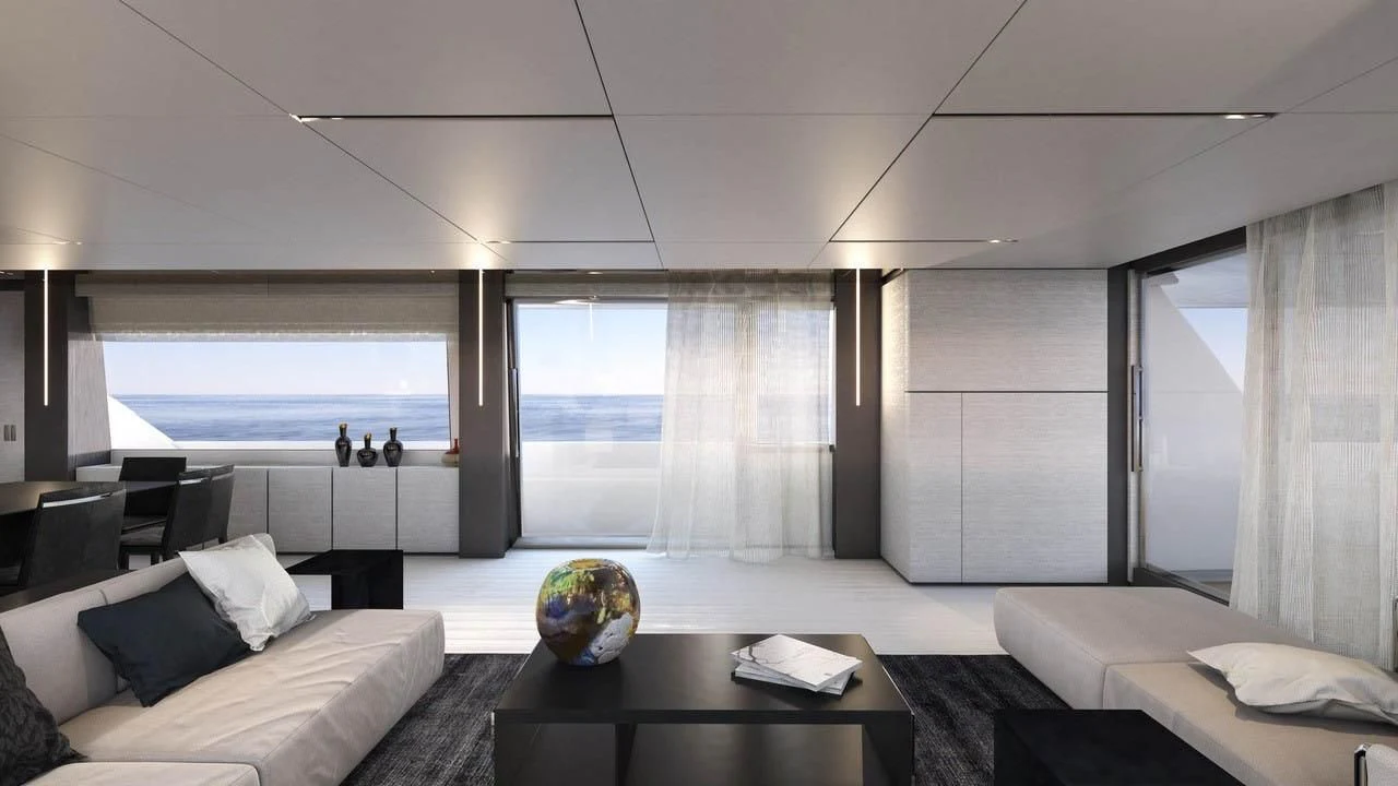 a room with a large window and a table with a large white sofa aboard NEWAL Yacht for Sale