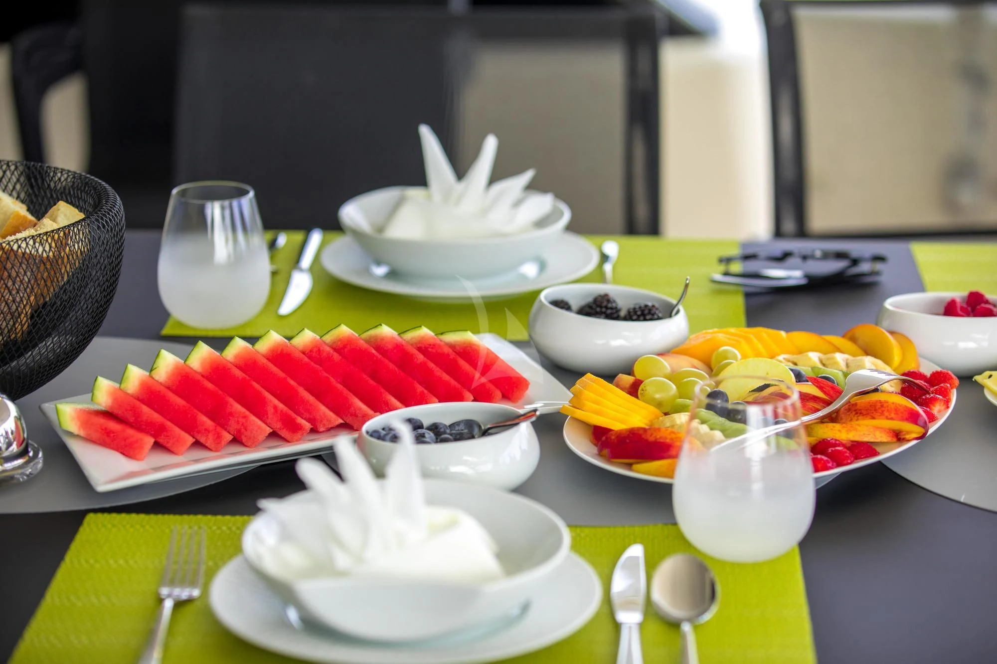 a table with plates and bowls of food on it aboard NEWAL Yacht for Sale