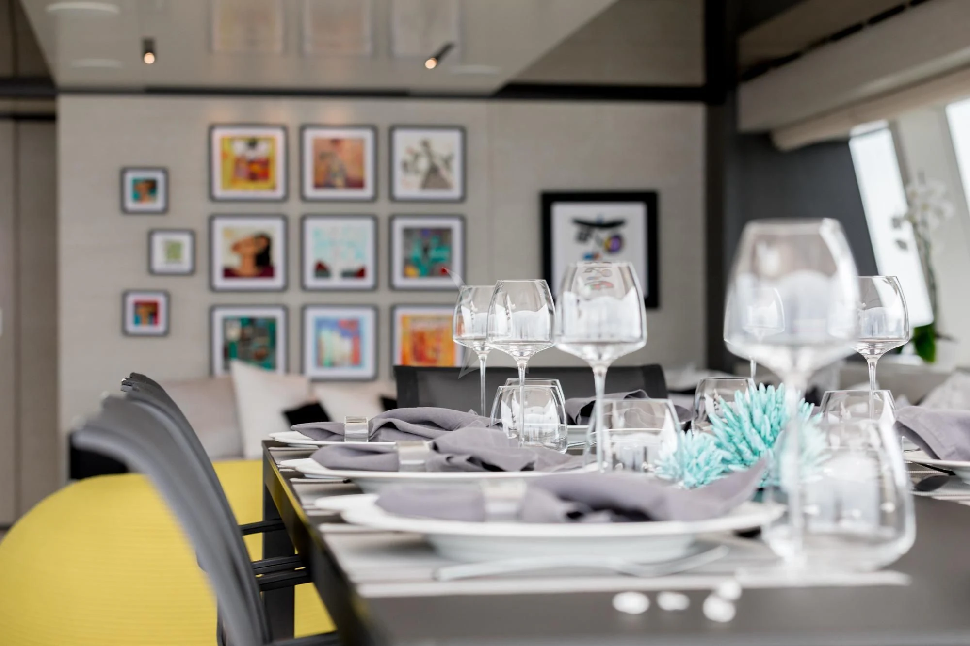a table with plates and glasses on it aboard NEWAL Yacht for Sale