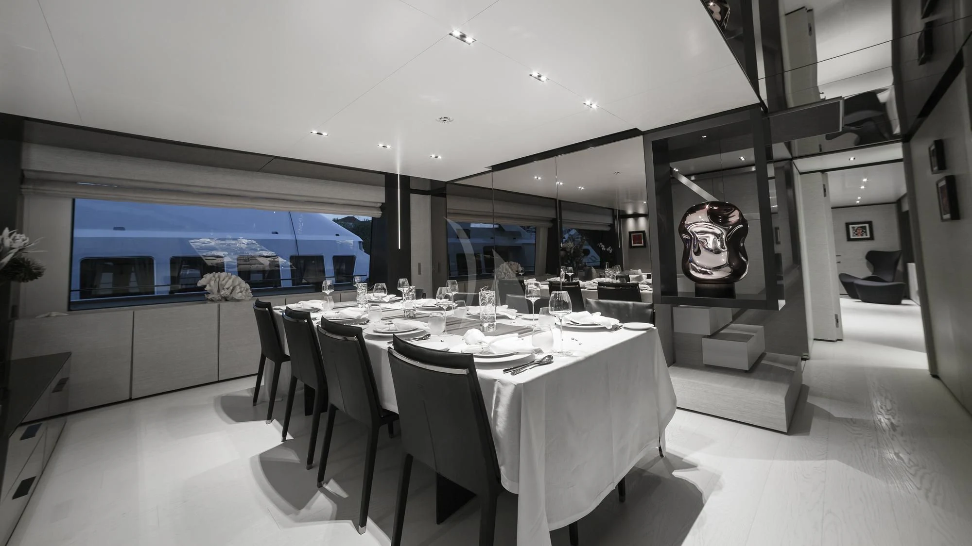 a large dining room with white tables aboard NEWAL Yacht for Sale