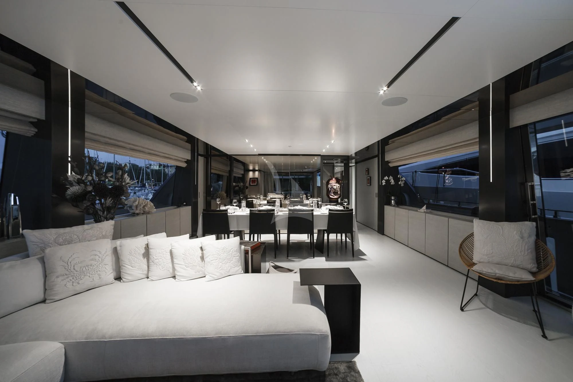 a living room with a large white sofa and a large window aboard NEWAL Yacht for Sale