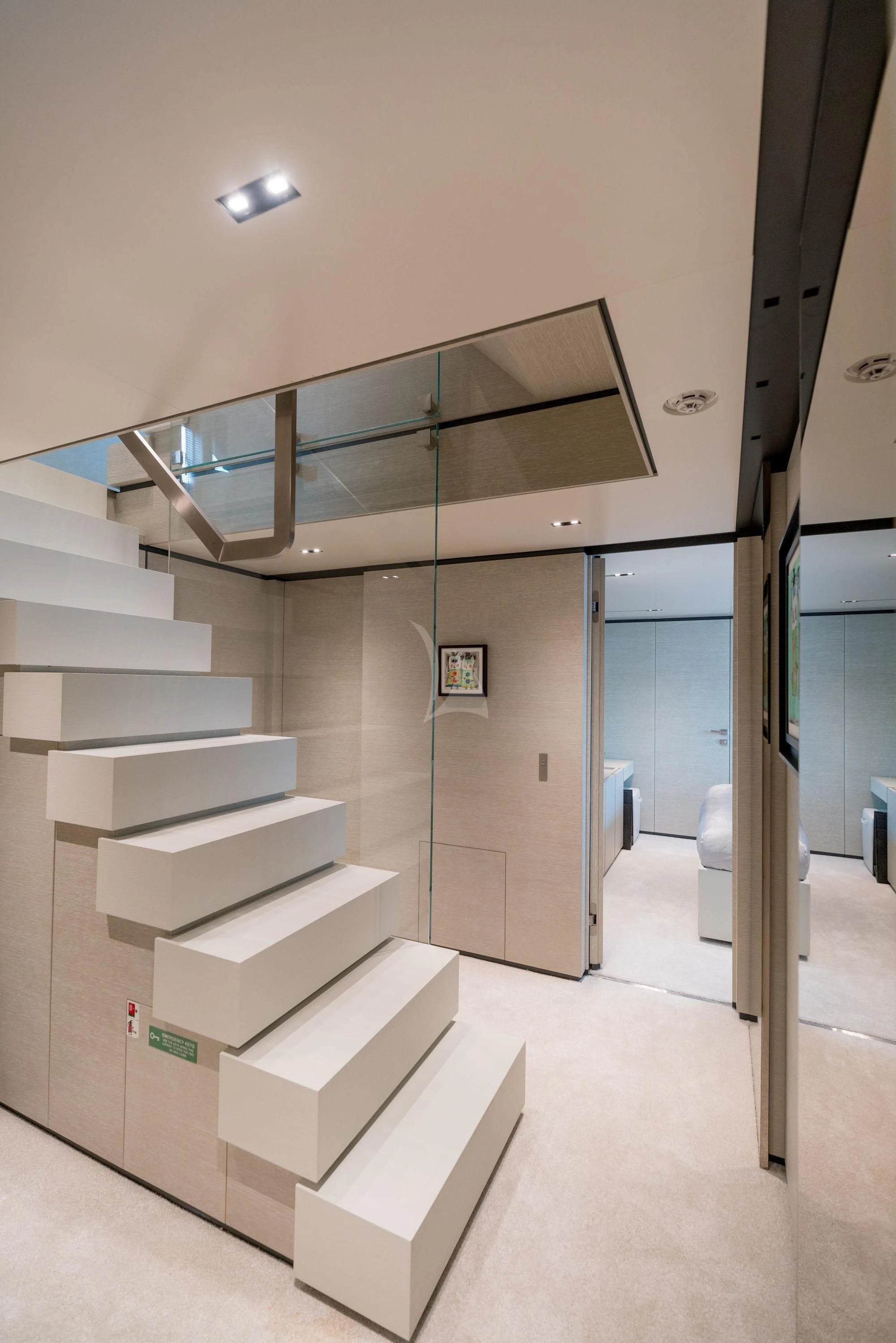 a staircase with glass doors aboard NEWAL Yacht for Sale