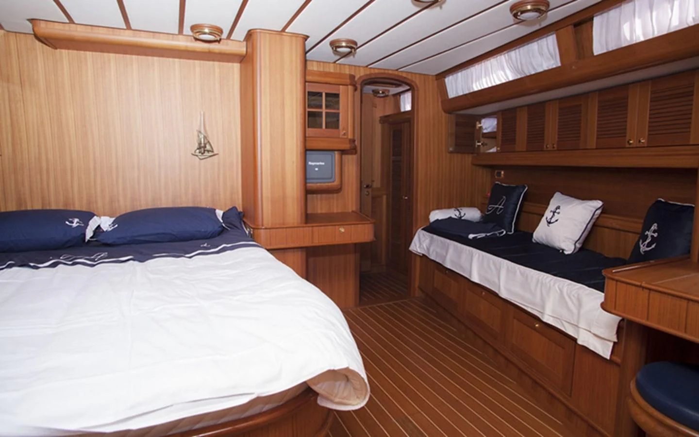 a room with beds and a wood closet aboard ARCADIA 3 Yacht for Sale