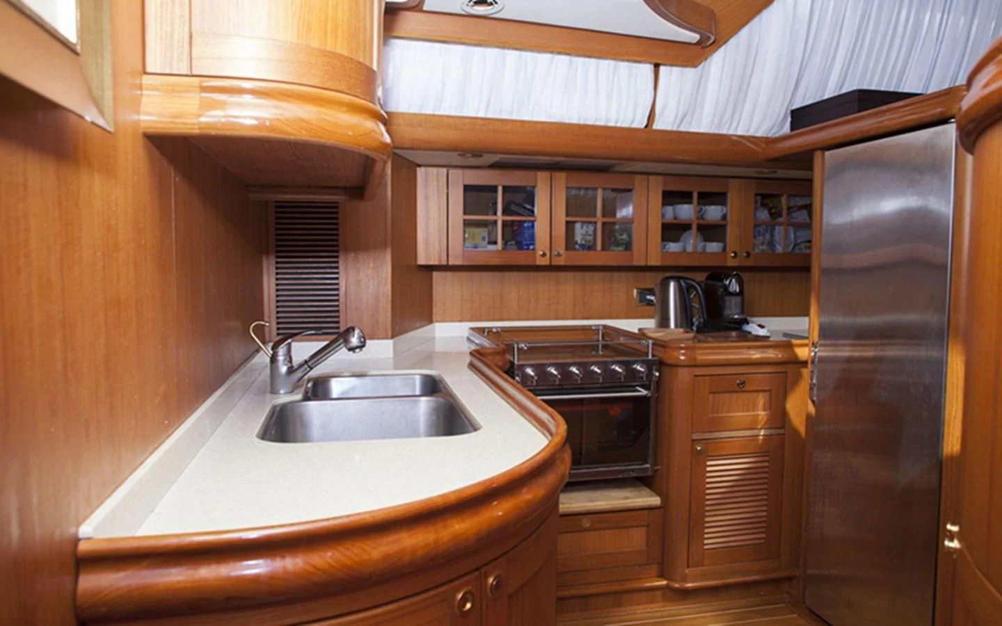 a kitchen with wooden cabinets aboard ARCADIA 3 Yacht for Sale